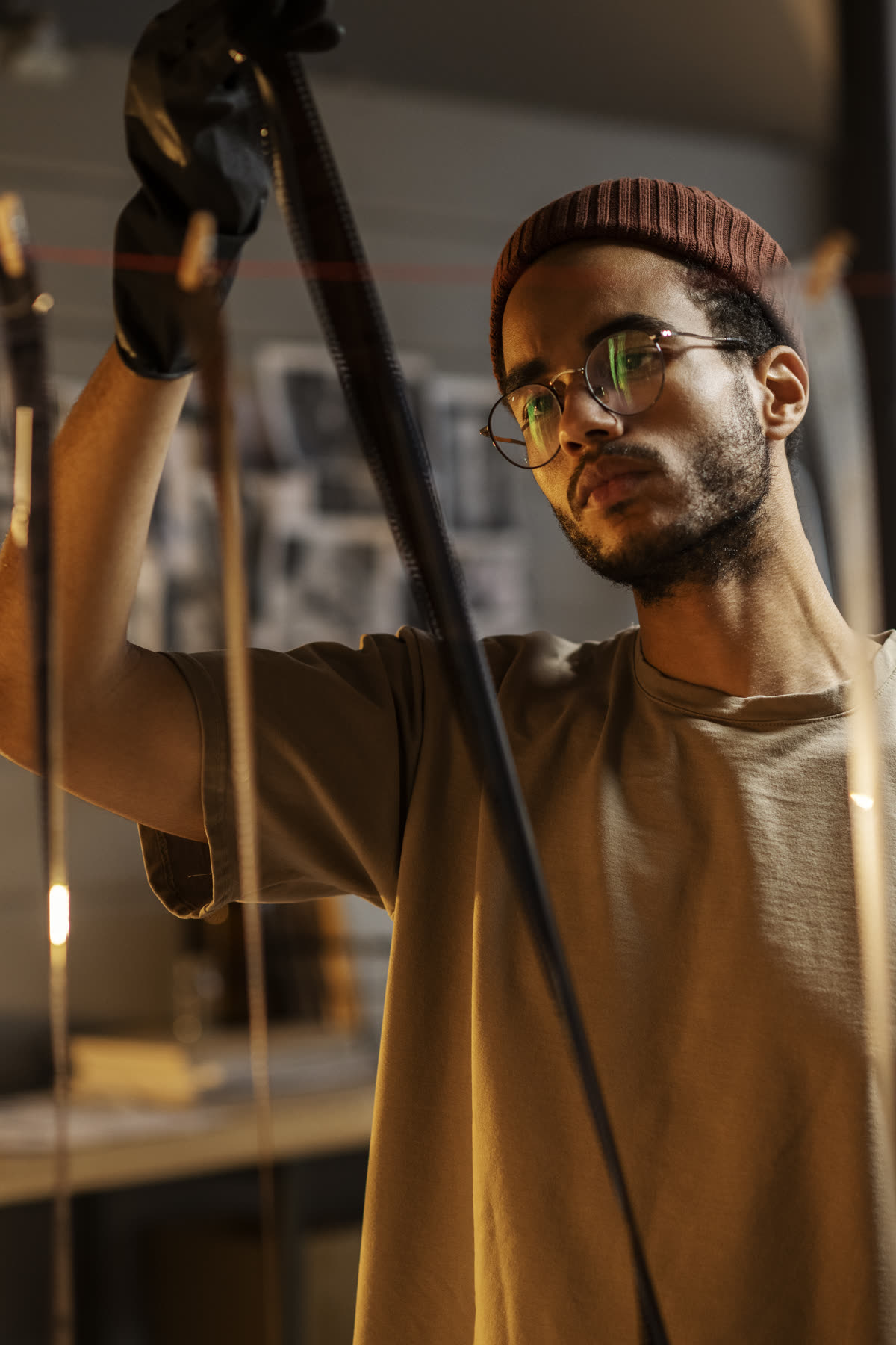 A photographer hanging film to dry in a darkroom