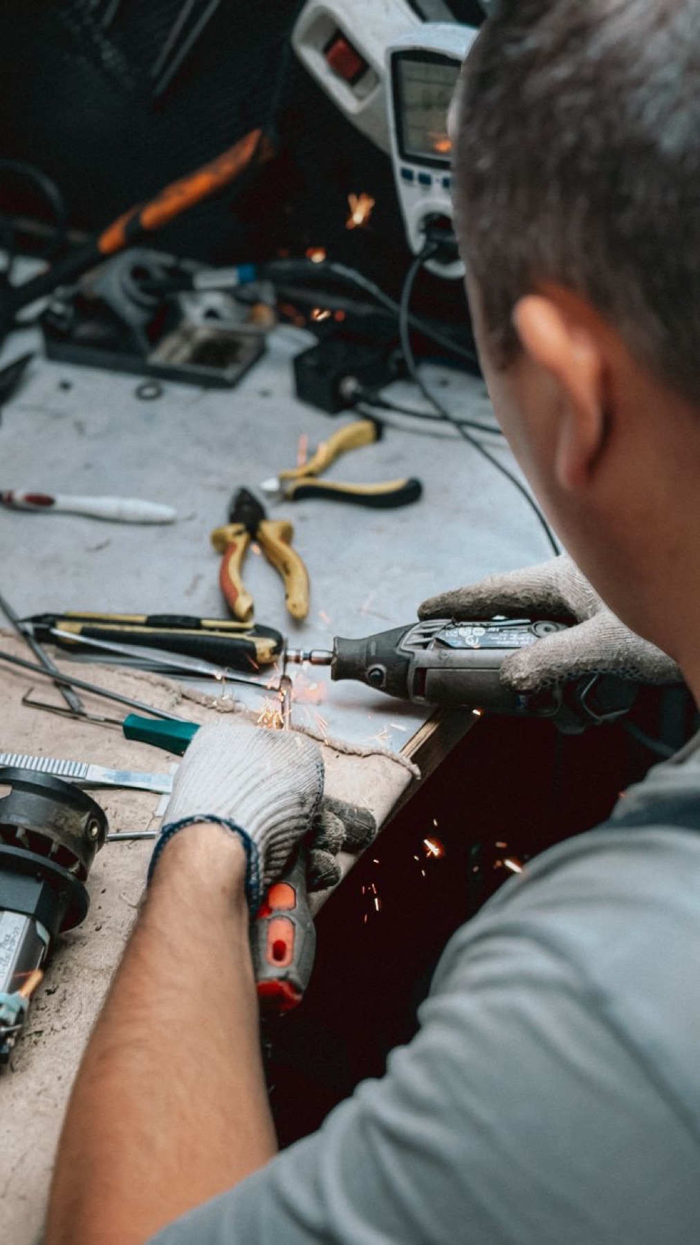 A tradesperson at a workbench with tools