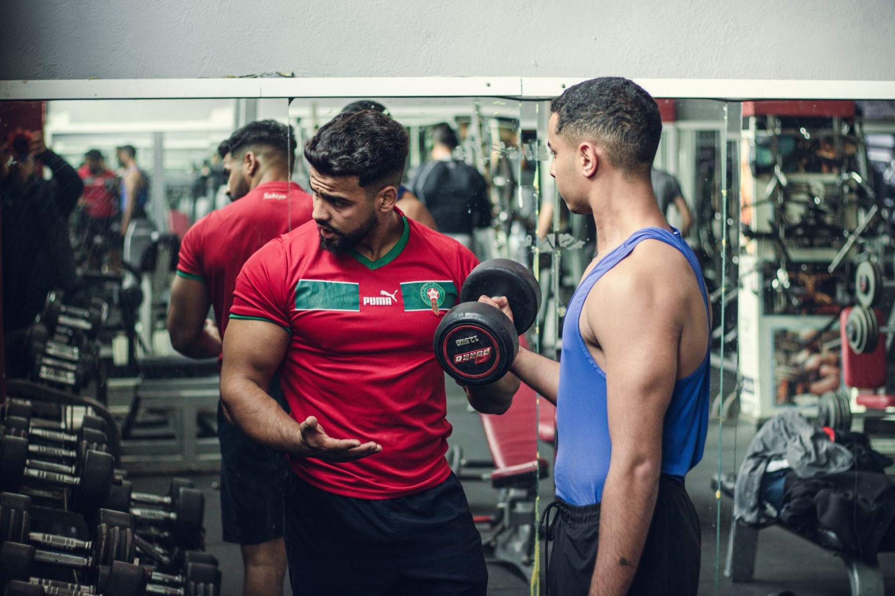 A trainer coaching a member through a lift