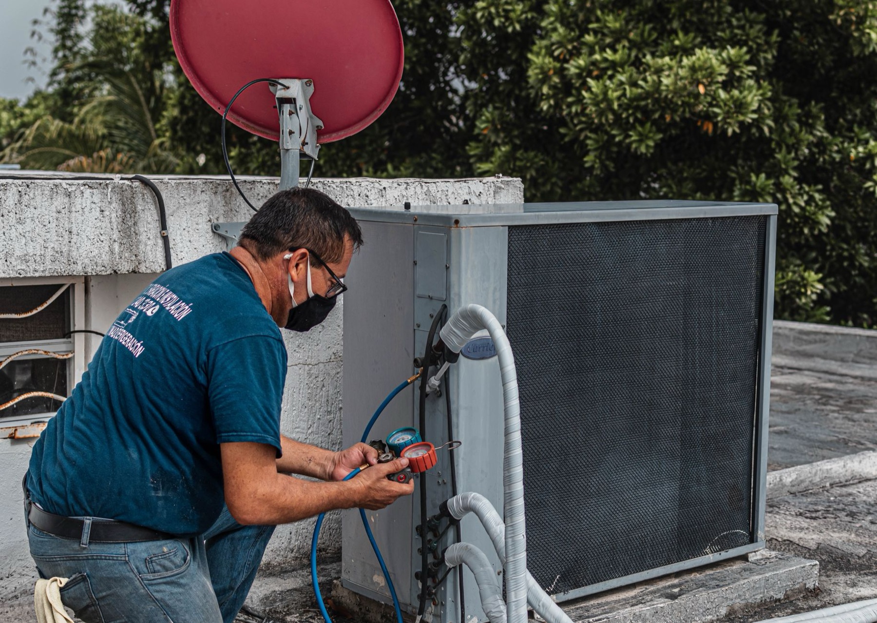 Hands working on an HVAC system outdoors